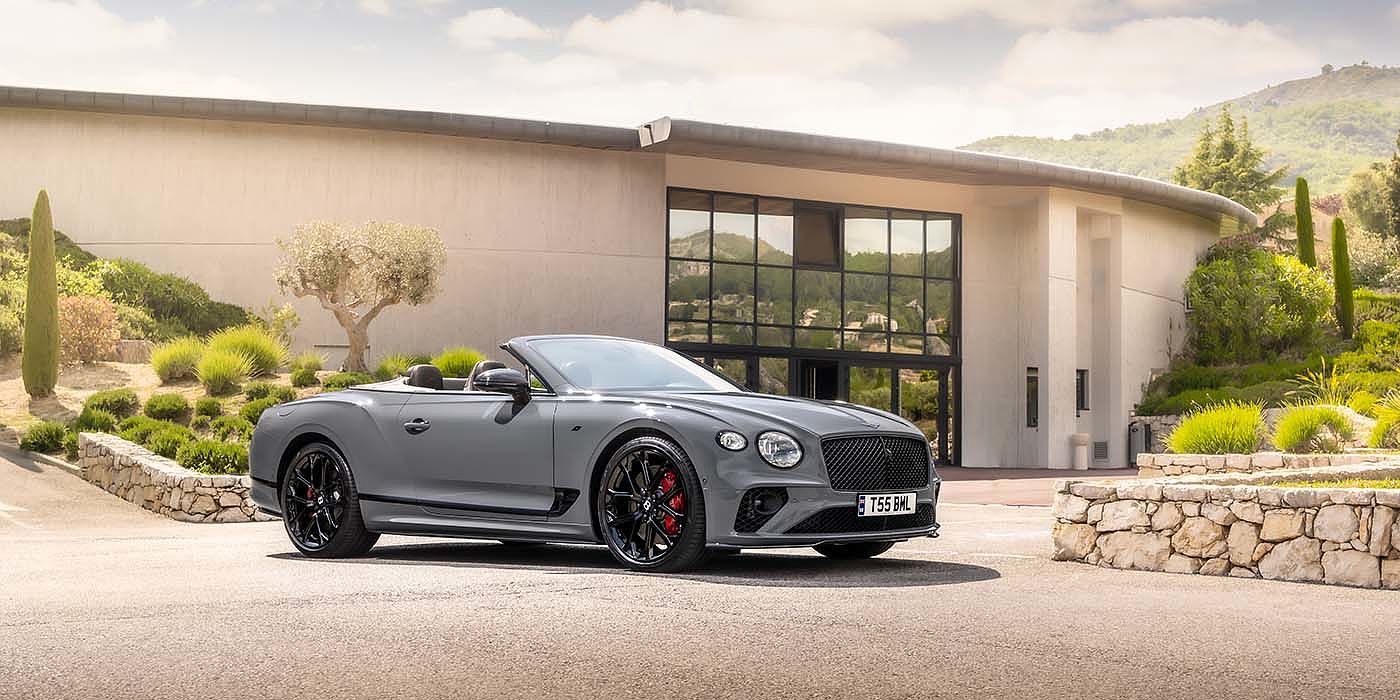Bentley Braga Bentley Continental GTC S convertible in Cambrian Grey paint front 34 static near house